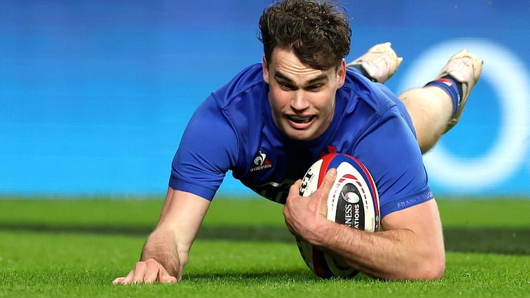 France's Damian Penaud scores a try during the Six Nations...