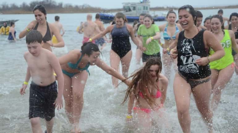 Nearly 400 people plunged into the 37-degree water at Tobay...