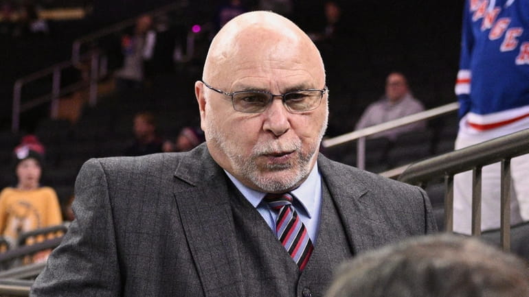 Nashville Predators GM Barry Trotz walks down from the stands...