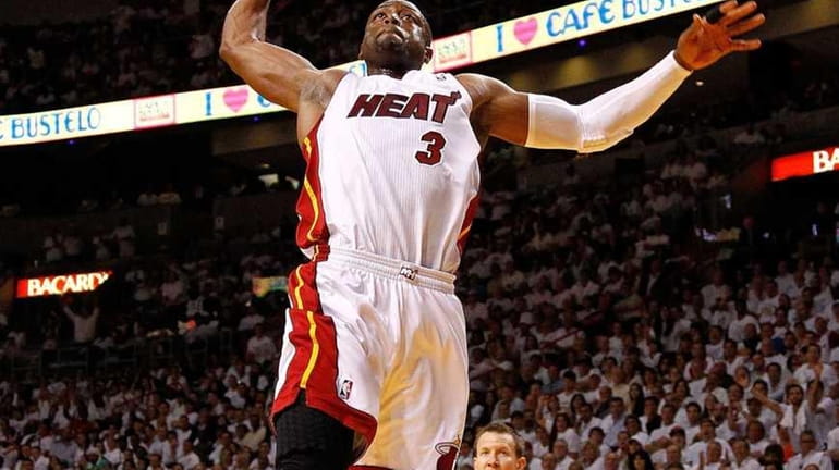 Dwyane Wade #3 of the Miami Heat drives to the...