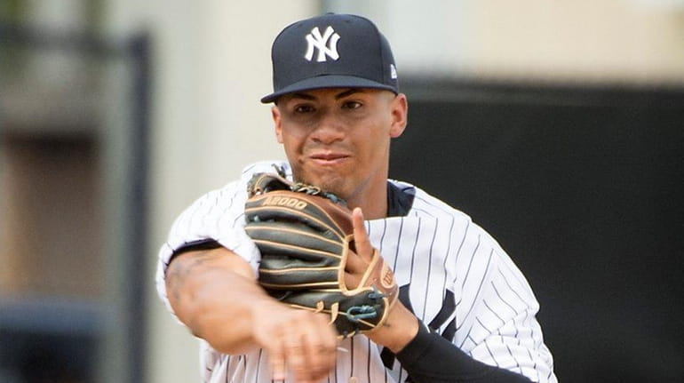 The Yankees' Gleyber Torres fields a ball during spring training...
