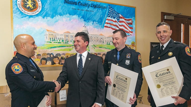 Nassau County Police Benevolent Association President Tommy Shevlin congratulates Nassau...