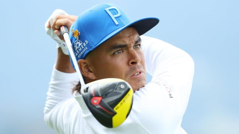 Rickie Fowler plays a shot from the 14th tee during...