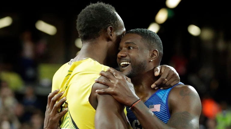 Gold medal winner United States' Justin Gatlin, right, embraces Jamaica's...