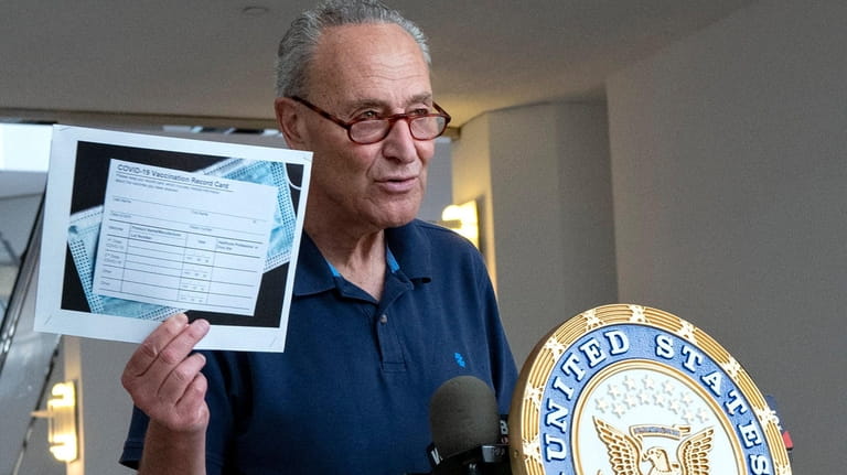 Sen. Chuck Schumer (D-N.Y.) displays the image of a blank...