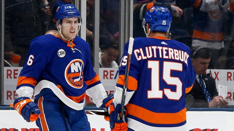 Ryan Pulock #6 of the New York Islanders celebrates his...