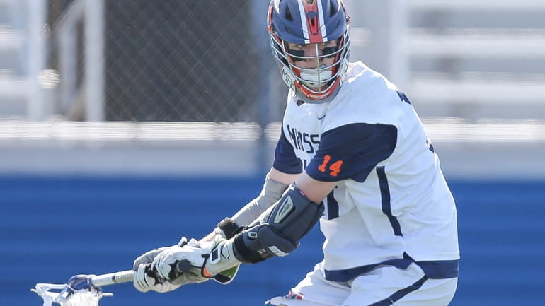 Manhasset's Liam Connor (14) fires a shot and scores in...
