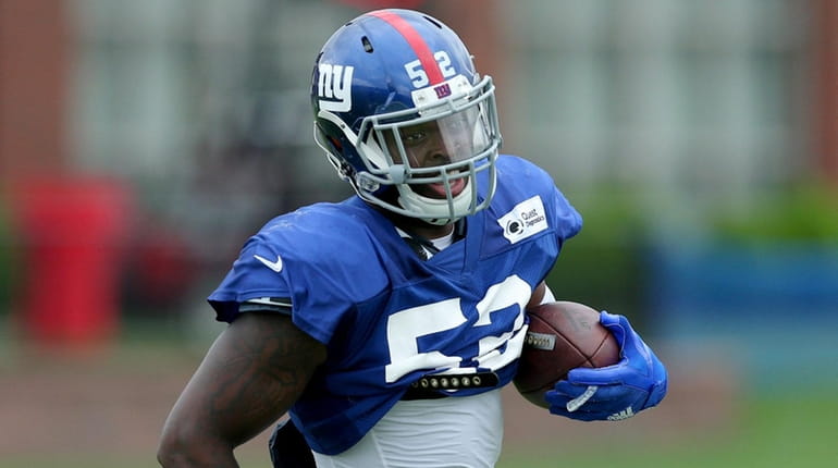 Giants linebacker Alec Ogletree runs with the ball during training...
