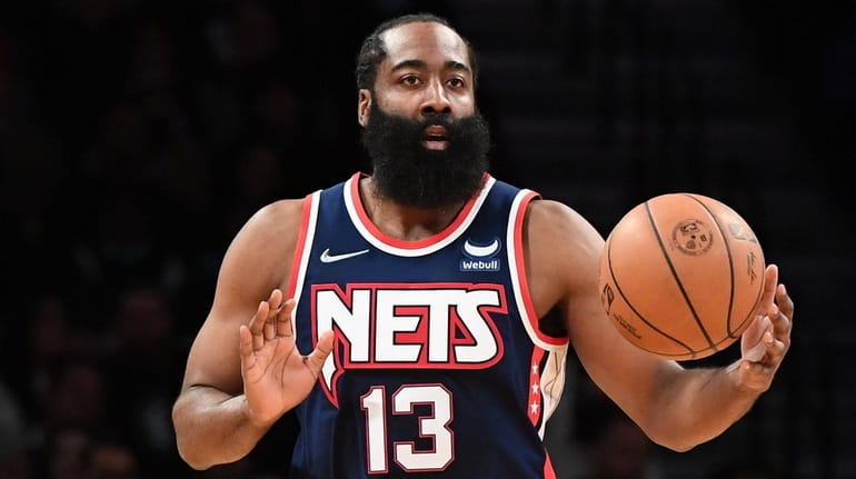 Nets guard James Harden dribbles the ball up court against...