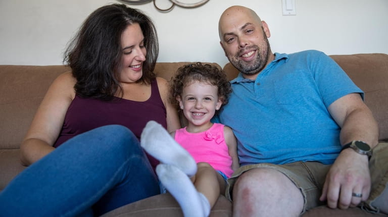 Victoria Neary, 37, left, Rosaria Neary, 4, and Dennis Neary, 40,...