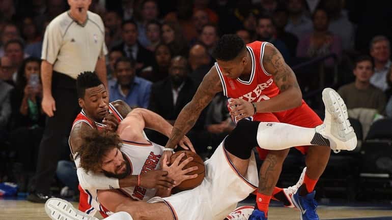 New York Knicks center Robin Lopez fights for a lose...