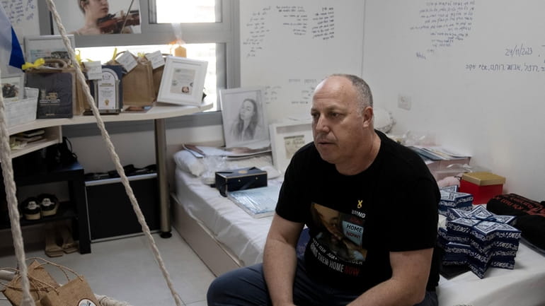 Shlomi Berger sits in his daughter's bedroom in Holon, Israel,...
