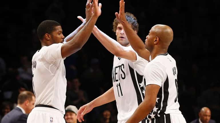 Joe Johnson of the Brooklyn Nets celebrates with teammates Brook...