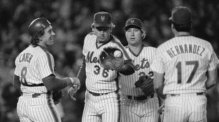 Mets catcher Gary Carter, left, congratulates pitcher Ed Lynch after...