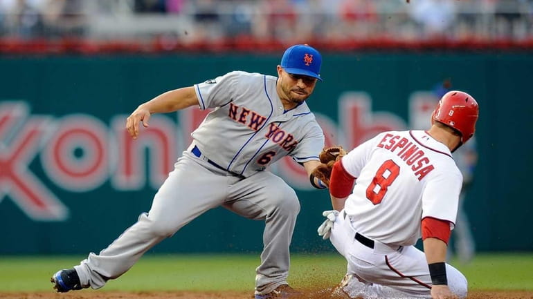 Danny Espinosa of the Washington Nationals steals second base against...