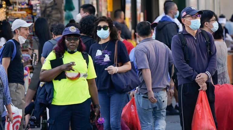 Pedestrians wear protective masks during the coronavirus pandemic.