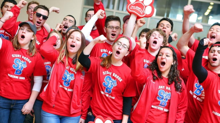 The Stony Brook Marching Band cheers during a school send-off...
