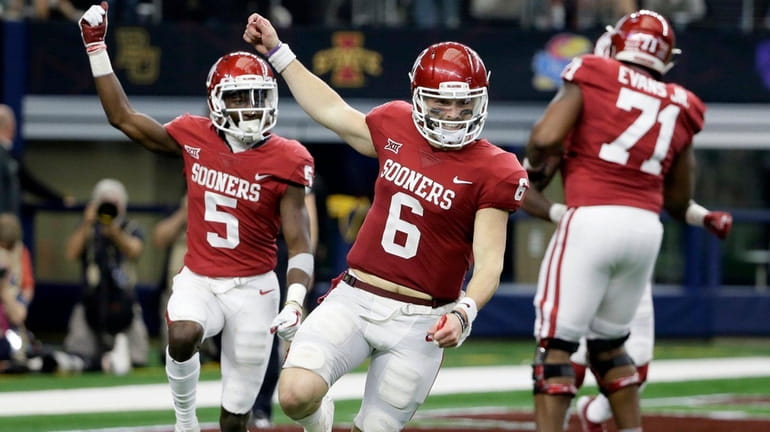 Oklahoma quarterback Baker Mayfield and wide receiver Marquise Brown celebrate...