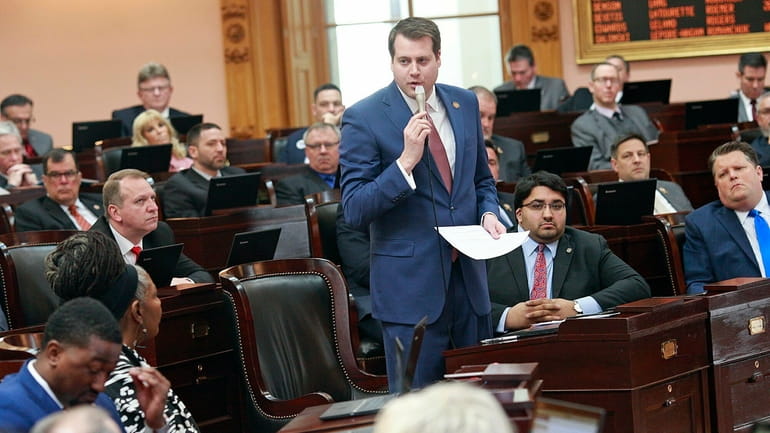Ohio Rep. Derek Merrin stands while he advocates a yes...