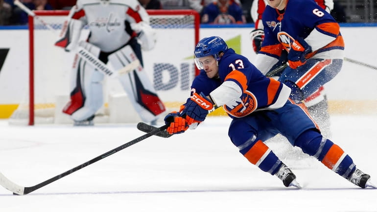 Mathew Barzal of the New York Islanders controls the puck against...