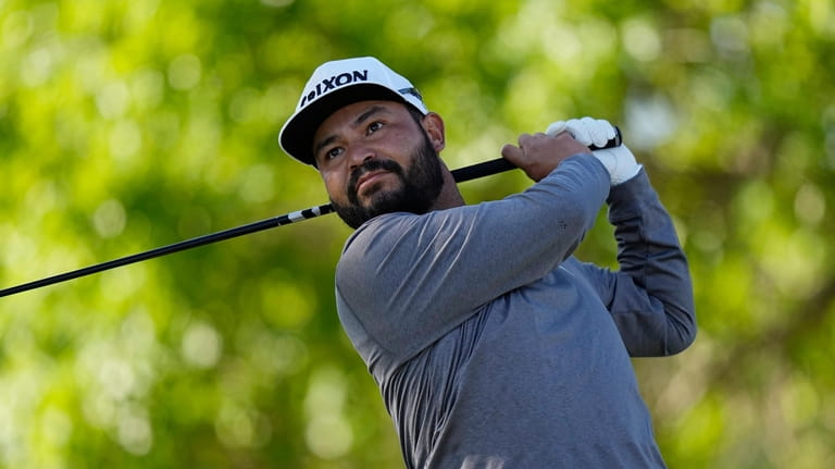J.J. Spaun watches his drives on the sixth hole during...