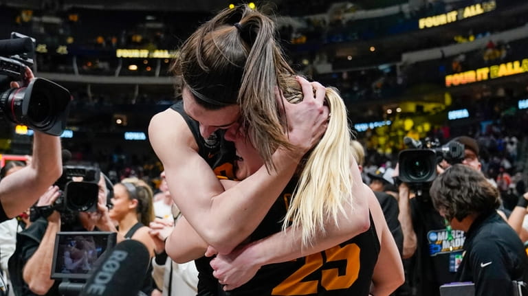 Iowa's Caitlin Clark and Monika Czinano celebrate after an NCAA...