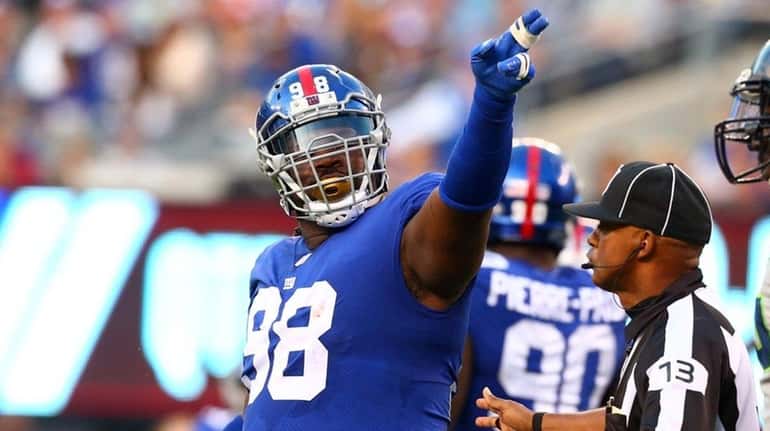 Damon Harrison of the Giants signals first down after a...