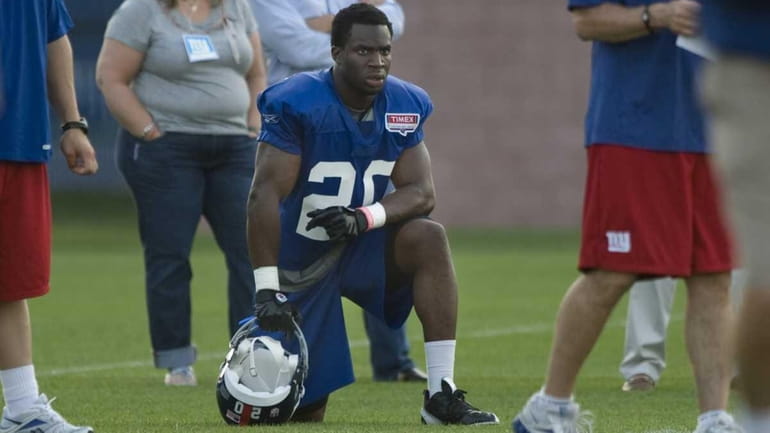 Prince Amukamara watches practice from the sidelines during NY Giants...