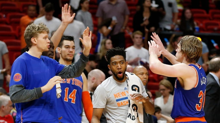 New York Knicks' Ron Baker, right, celebrates with teammates during...