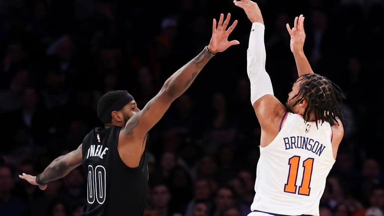New York Knicks guard Jalen Brunson (11) shoots a three...