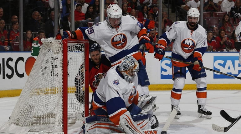 Islanders' Thomas Greiss defends against a shot by the Florida...