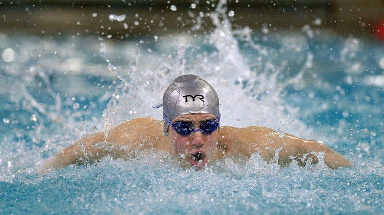 Syosset's Tamir Zitelny swims in the 100-yard butterfly during the...