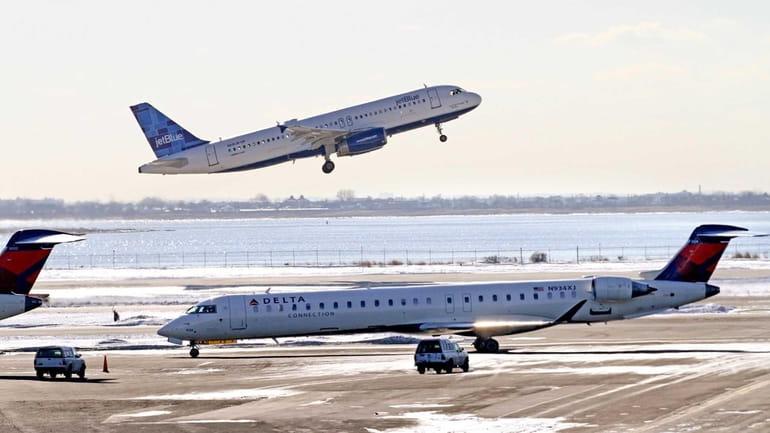 A Delta Connection CRJ-900 regional jet taxis near Terminal 2...