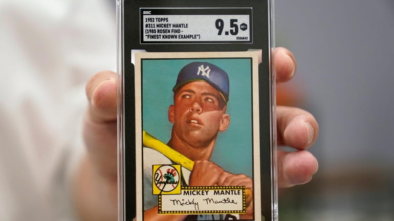 A Mickey Mantle baseball card is displayed at Heritage Auctions...