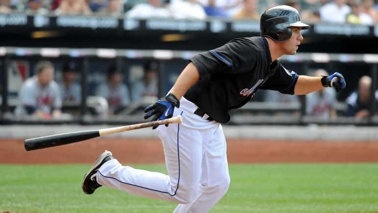 New York Mets pinch hitter Josh Thole (30) hits and...