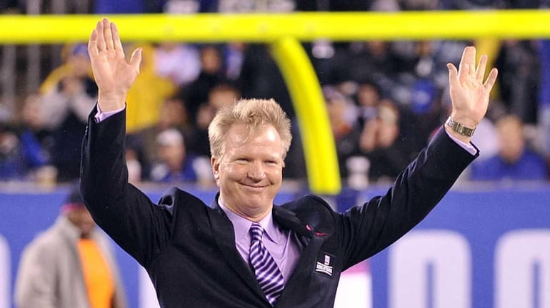 Phil Simms waves to the fans as he is inducted...