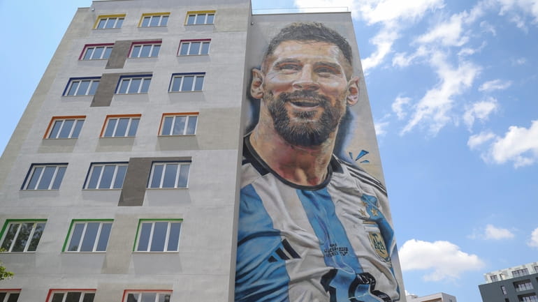 A mural with Argentinian soccer superstar Lionel Messi, is painted...