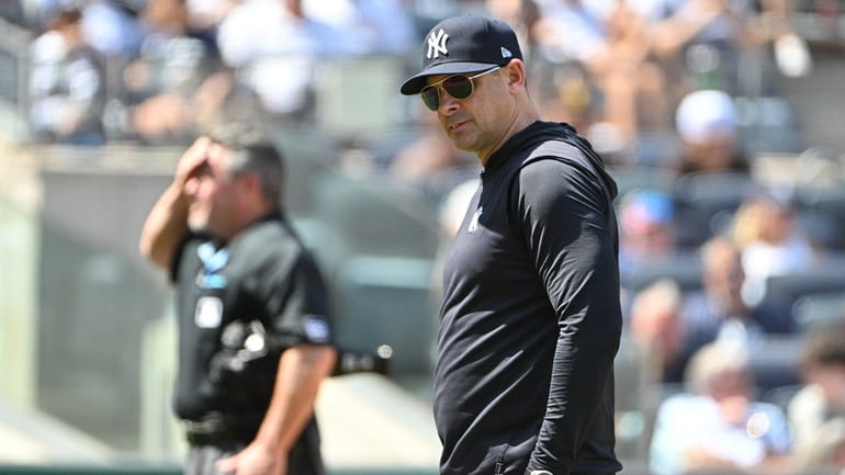 Yankees manager Aaron Boone walks to the dugout after a...