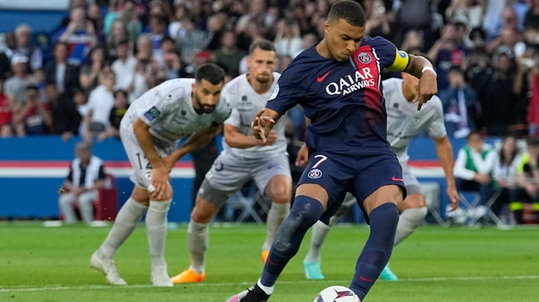 PSG's Kylian Mbappe scores his side's second goal from a...