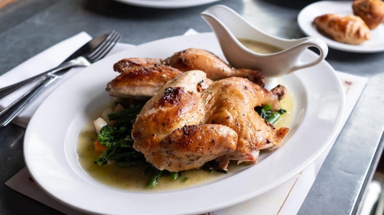 The roast chicken for two served over vegetables at Bistro Cassis...