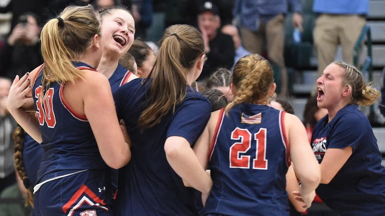 Cold Spring Harbor teammates celebrate after their 58-56 win over...
