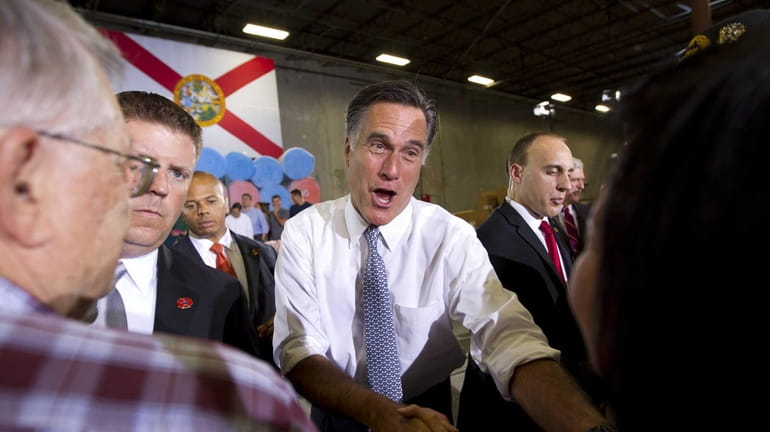 Mitt Romney, the presumed Republican nominee for president, shakes hands...