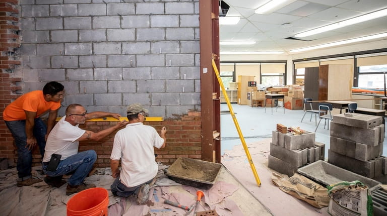 Workers build a new rotunda area at Jack Abrams STEM...