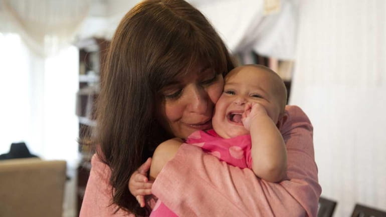 Tammy Hayempour holds her daughter, Esther Miriam. Police say Gloria...