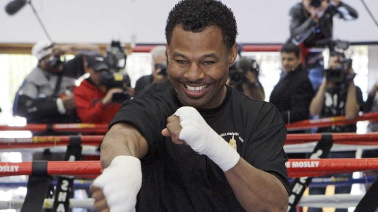 Shane Mosley shadow-boxes during a workout in front of the...