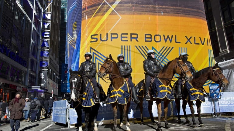 NYPD mounted officers stand guard along Super Bowl Boulevard near...