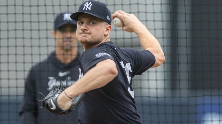 Yankees’ pitcher Clarke Schmidt throwing during live batting practice with...