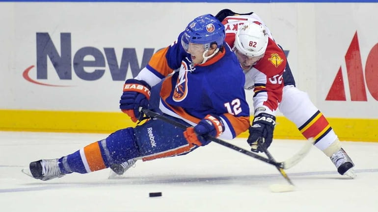 Josh Bailey of the Islanders loses the puck as he...