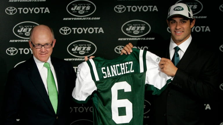 Jets owner Woddy Johnson, left, presents Mark Sanchez, quarterback from...