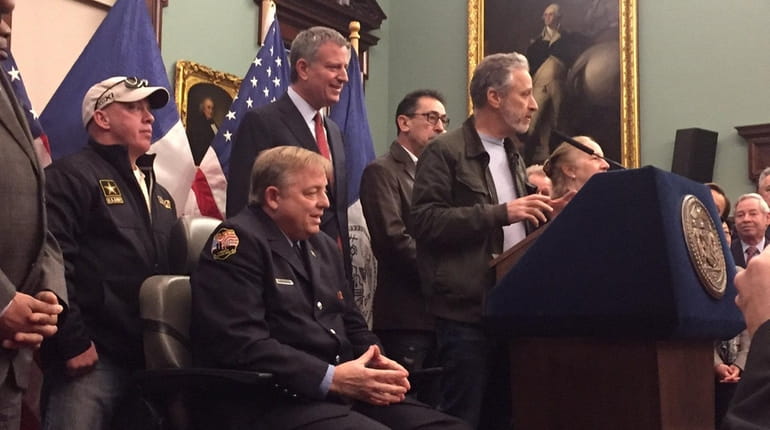 Retired FDNY firefighter Ray Pfeifer of Hicksville, seated, and Mayor...